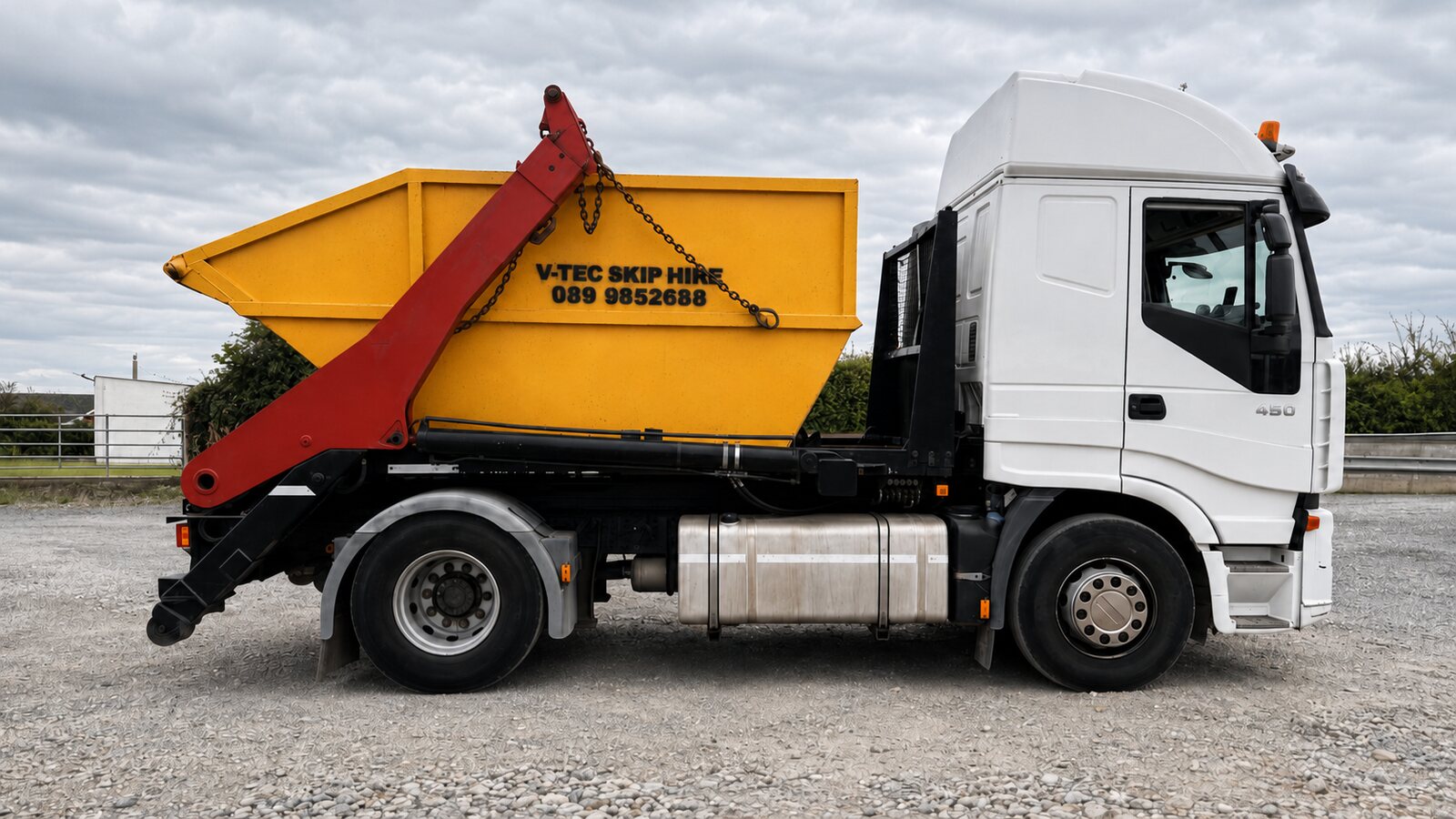 V-Tec Skip Hire yellow skip on gravel